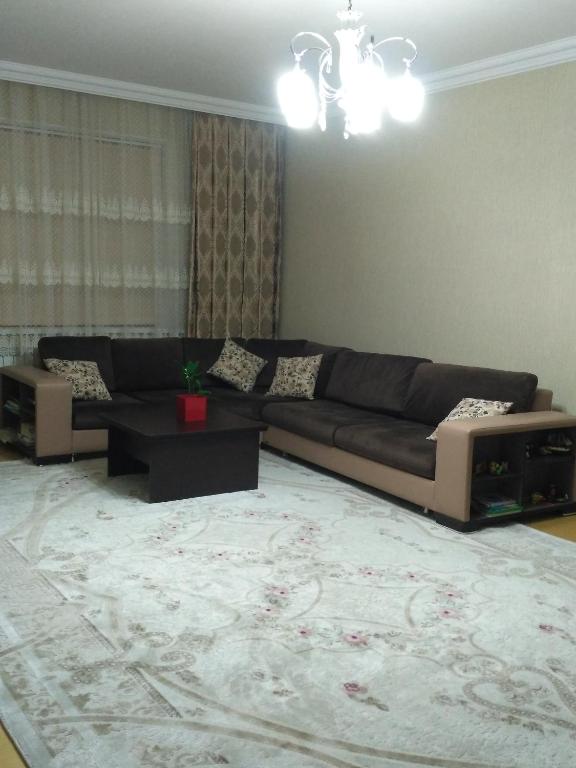 a living room with a couch and a rug at Sweet home Gusar. in Qusar