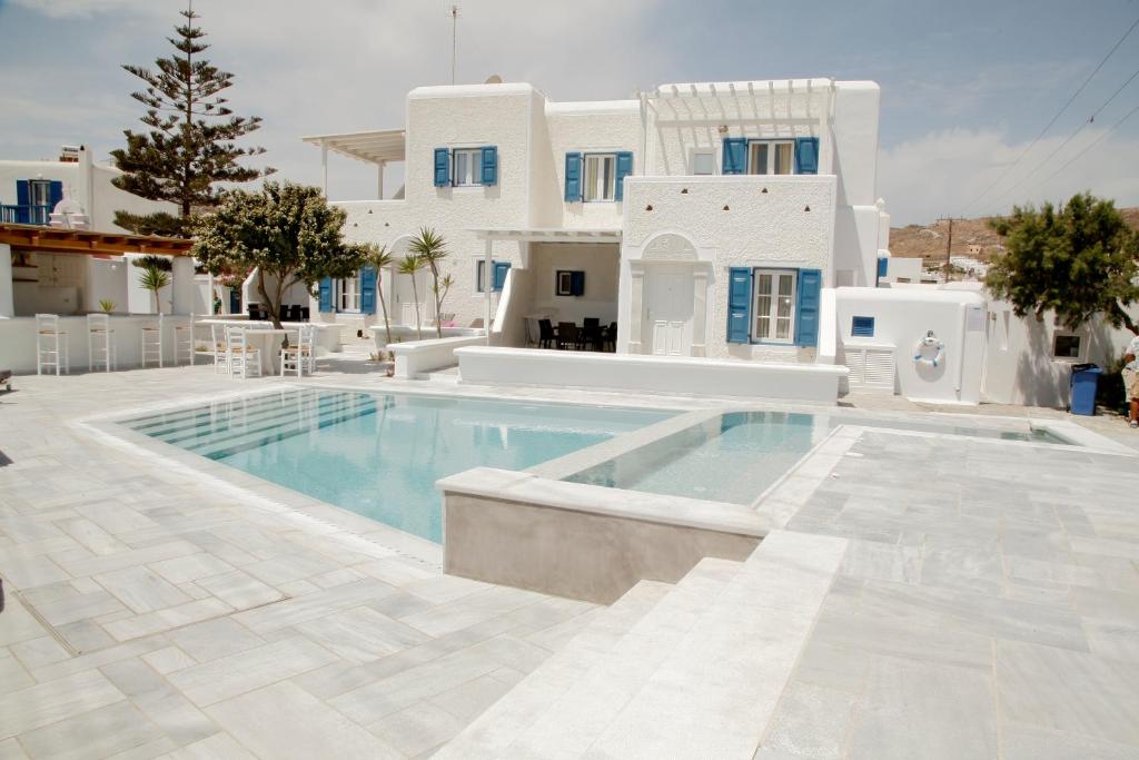 a swimming pool in front of a villa at Gelos House in Ornos