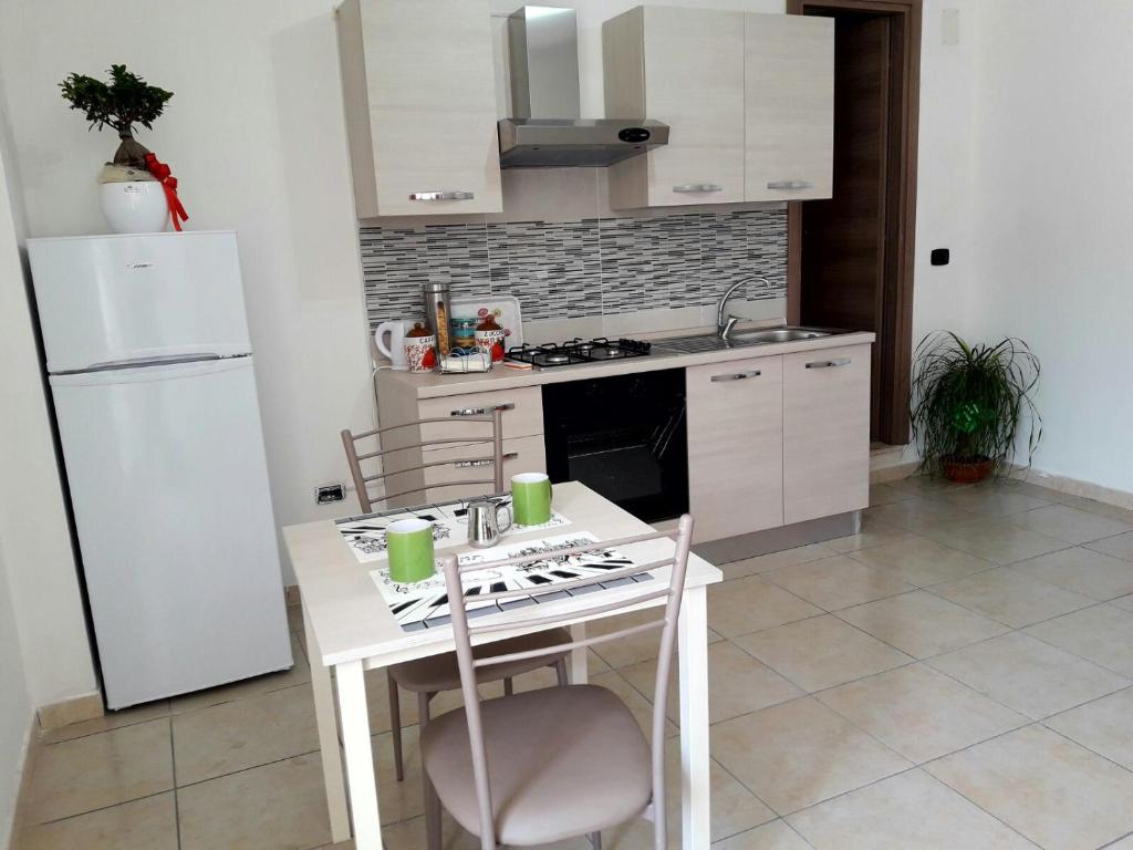 
a kitchen with a stove, sink, and refrigerator at FLY to NAPOLI in Naples
