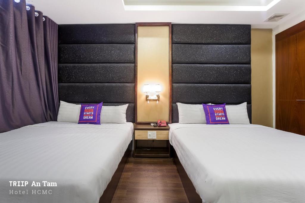 two beds sitting next to each other in a room at Mays Hotel- Ben Thanh Market in Ho Chi Minh City