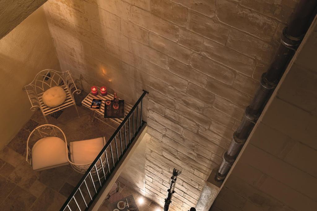an overhead view of a staircase with chairs and a table at The Snop House in Senglea