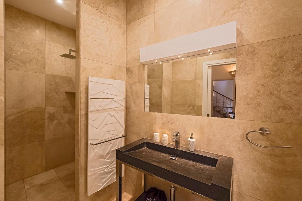 a bathroom with a sink and a mirror at The Snop House in Senglea