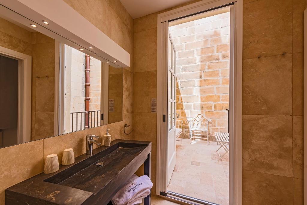 a bathroom with a large sink and a mirror at The Snop House in Senglea
