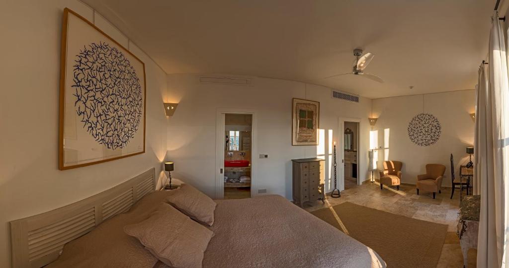a bedroom with a bed and a living room at The Snop House in Senglea