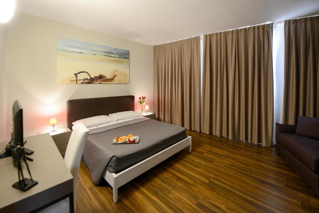 a bedroom with a bed and a couch at Residence Nazionale Matera in Matera