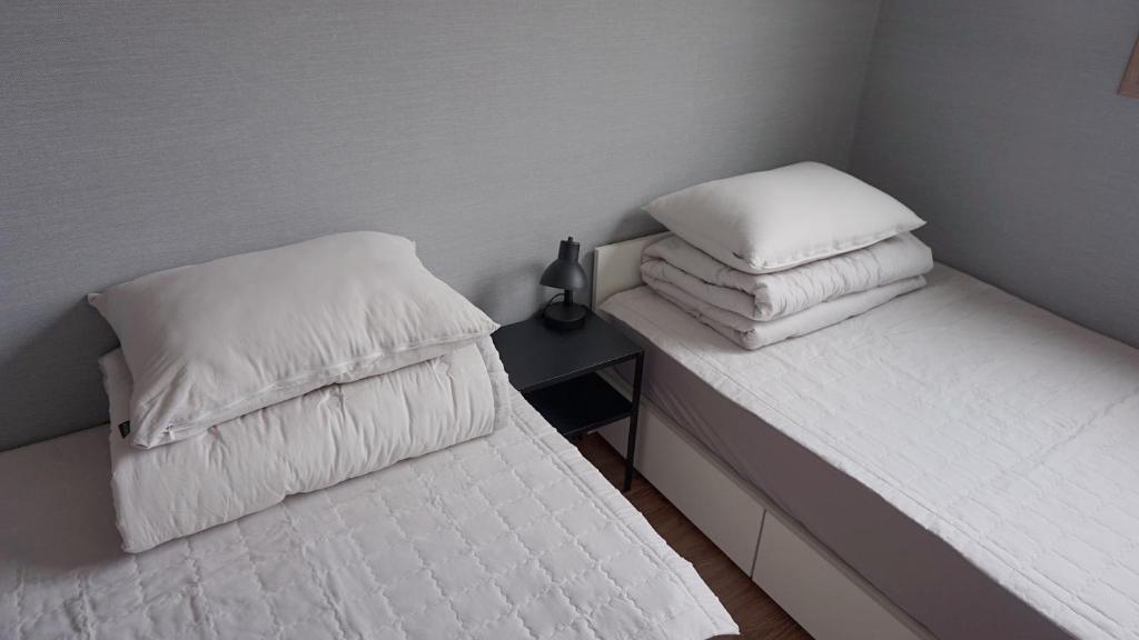 Postel nebo postele na pokoji v ubytování Sh Guesthouse
