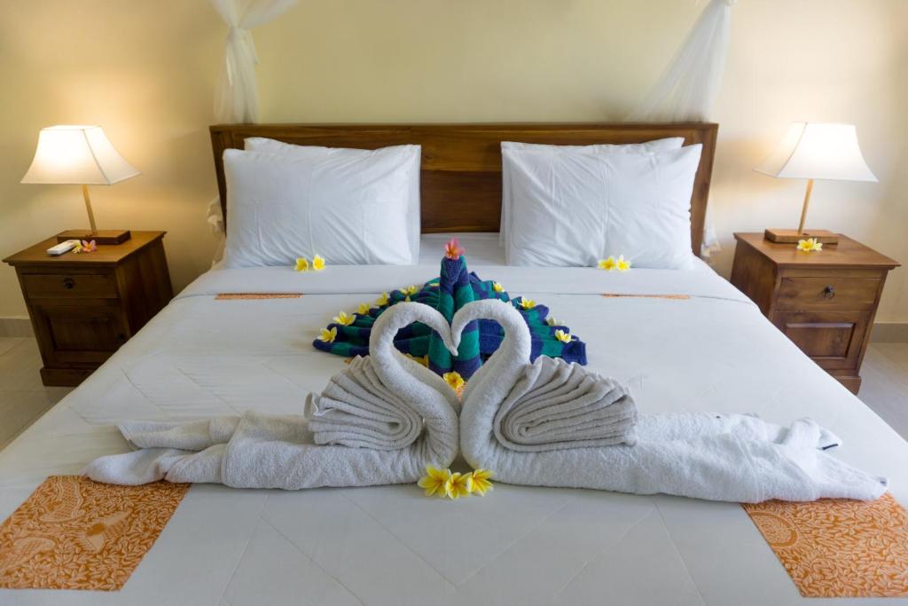Postel nebo postele na pokoji v ubytování Eka Bali Guest House