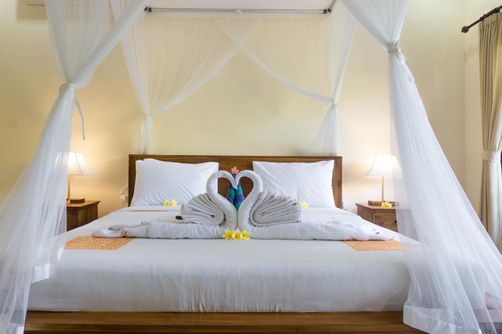 Postel nebo postele na pokoji v ubytování Eka Bali Guest House