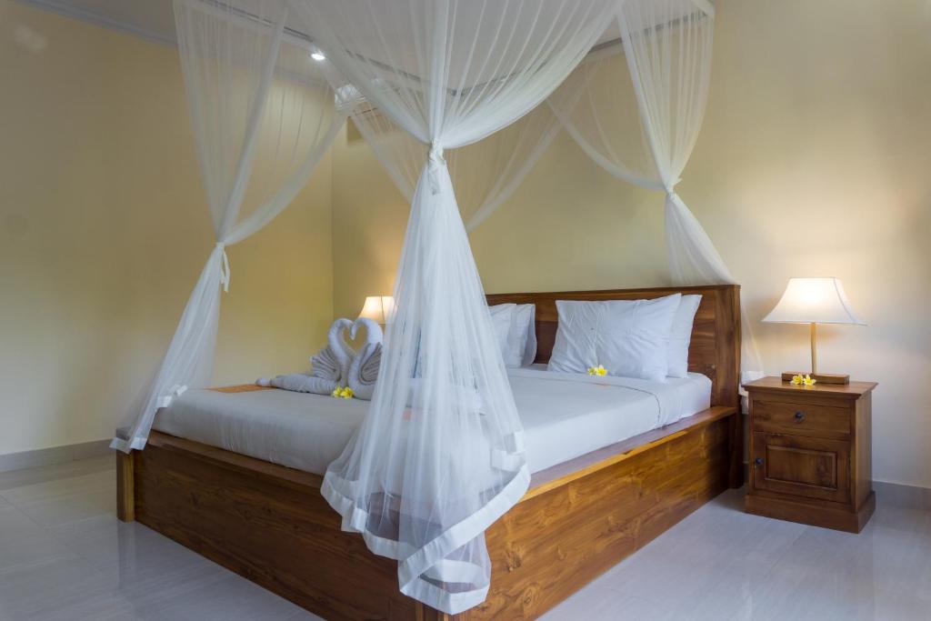 Postel nebo postele na pokoji v ubytování Eka Bali Guest House