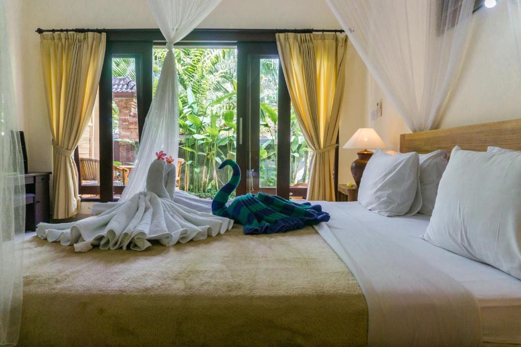 Postel nebo postele na pokoji v ubytování Eka Bali Guest House
