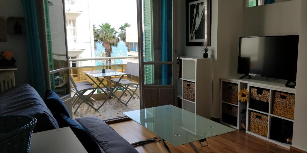 a living room with a couch and a glass table at Nice Seaview Free Parking 4.Pers in Nice