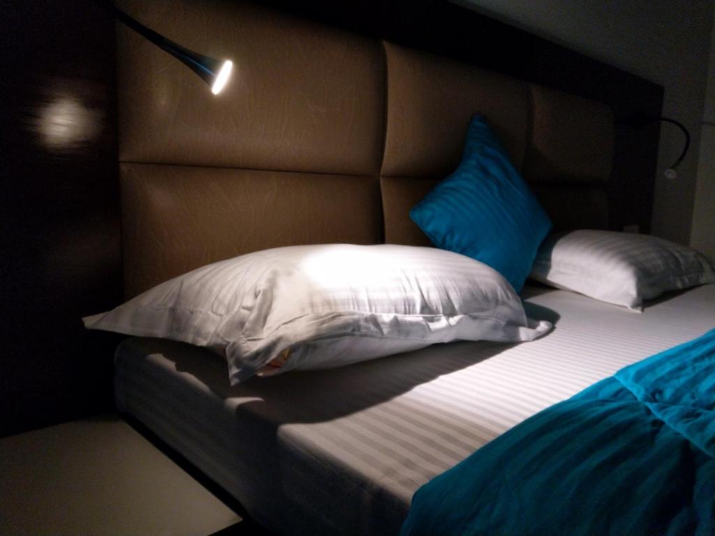 a bed with two pillows on it in a room at Joey's Hostel Delhi - 20 mins from Railway Station in New Delhi