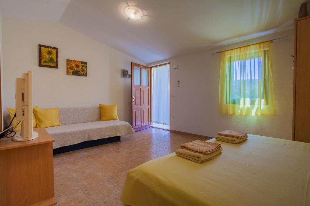 Postel nebo postele na pokoji v ubytování Apartments Dandić