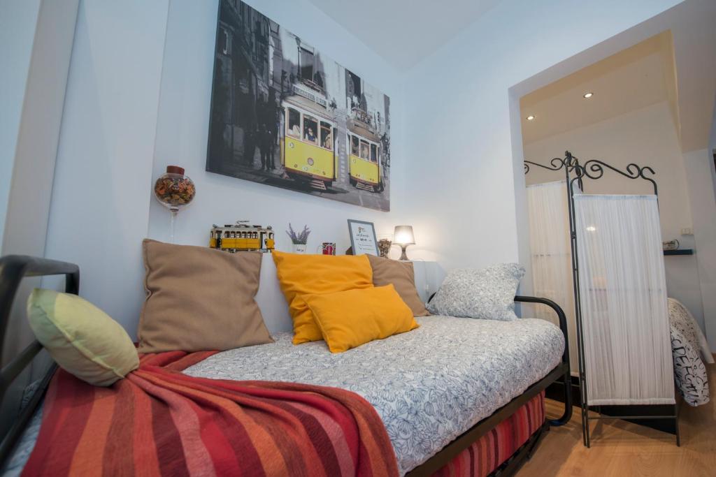 Bett mit gelben Kissen auf einem Zimmer in der Unterkunft Portugal here I Come - Alfama-Castelo in Lissabon