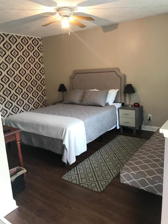 a bedroom with two beds and a ceiling fan at Nightshade Inn & Gardens in Camillus