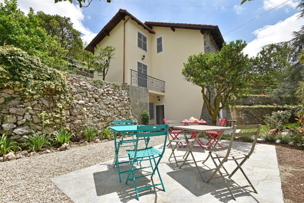 a kitchen with a table and chairs and a patio at Castelli in aria in Finale Ligure