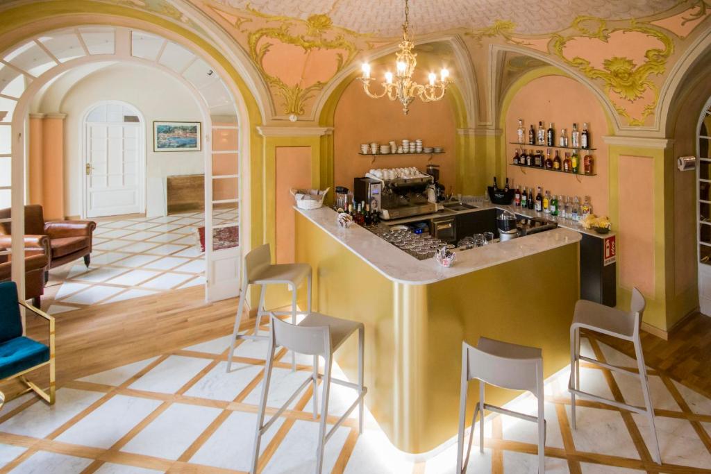 a restaurant with a bar with stools in a room at Mediterraneo Emotional Hotel & Spa in Santa Margherita Ligure