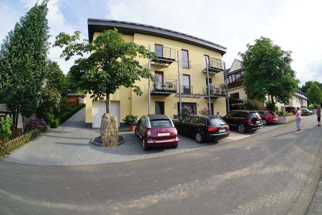 a street with cars parked in front of a building at Gaestehaus Jufferpanorama in Brauneberg