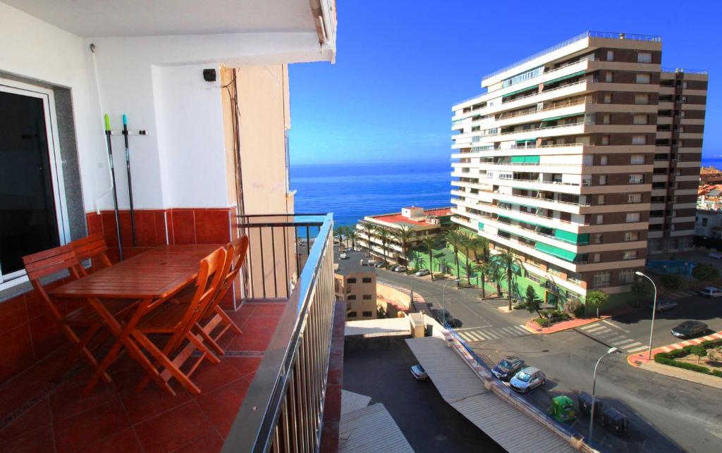 a balcony with a table and a view of the ocean at Expoholidays - Isla Azores in Aguadulce