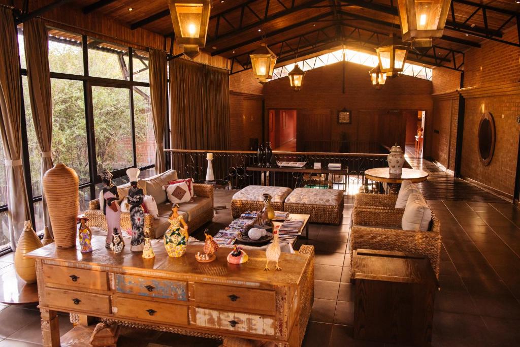 uma sala de estar com um sofá e uma mesa com vasos em Hotel Villa D'Angelo em Itatiba