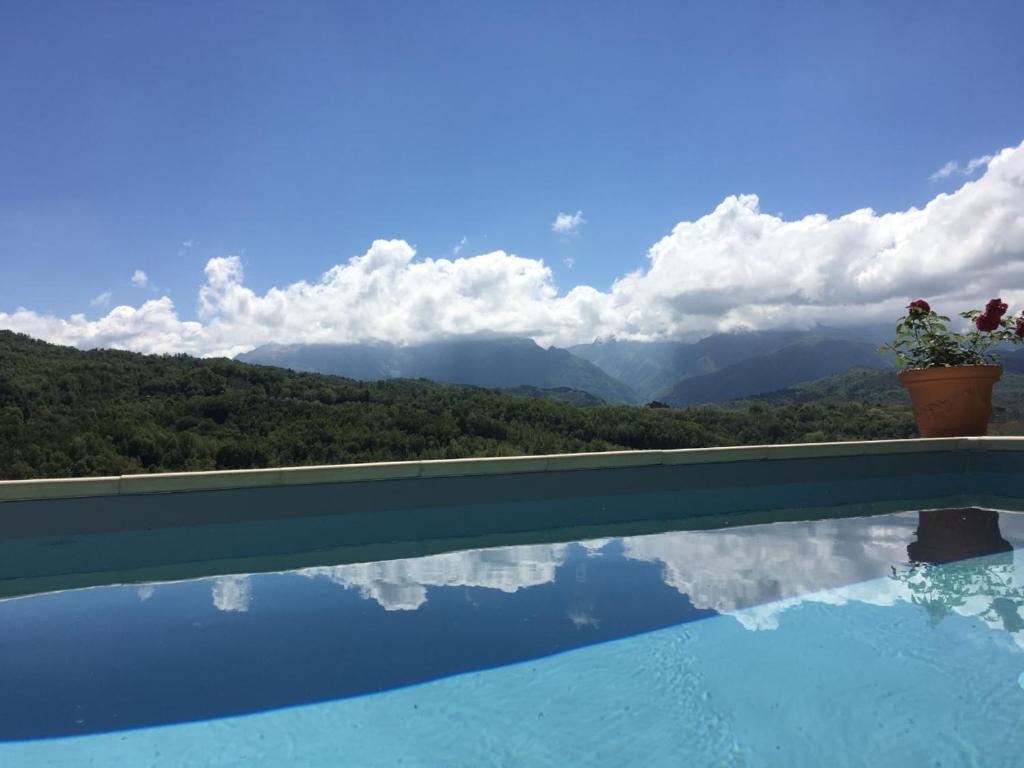 a swimming pool with a view of the mountains at Heavenly View in Fivizzano