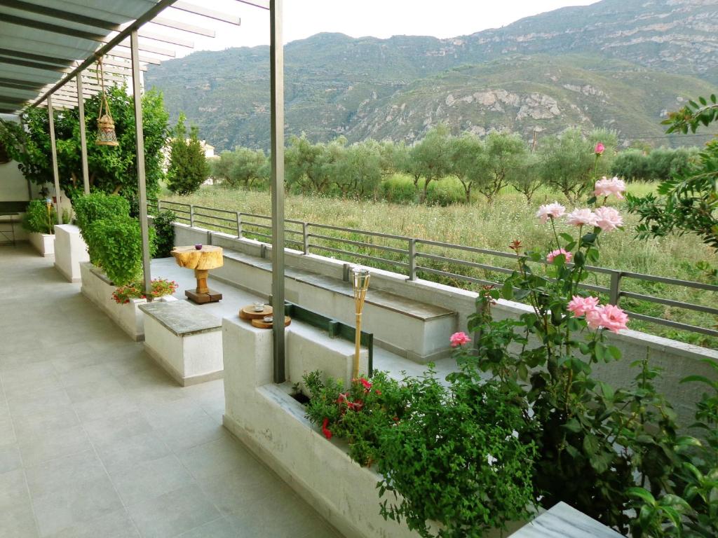 a balcony with flowers and a view of a mountain at The Kitehouse Apartments in Eleonas