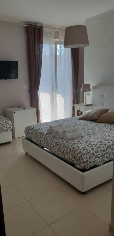 a bedroom with a bed and a large window at Home Sweet Home in Scerne