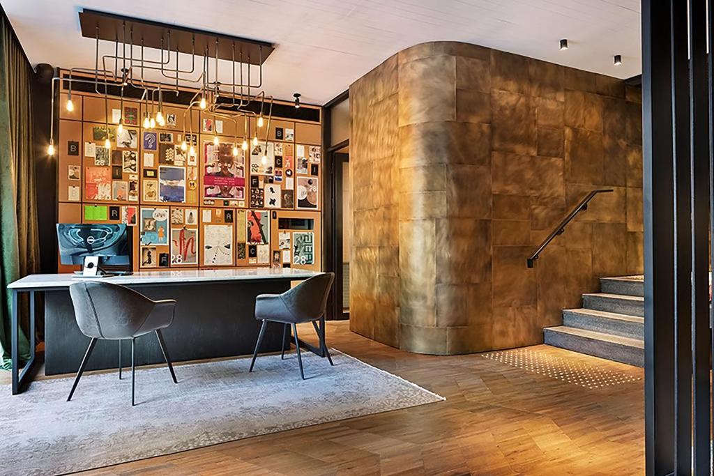 a living room with a wooden floor and a large window at Fabric Hotel - an Atlas Boutique Hotel in Tel Aviv