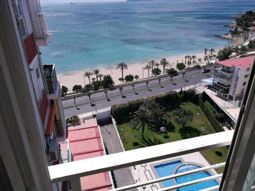 a view of the beach from the balcony of a building at Grandpa Beach House in Alicante