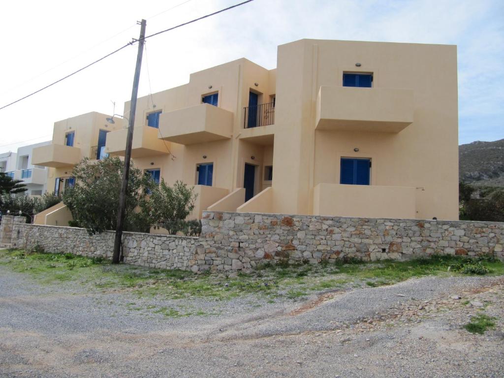 a house on the side of a stone wall at Eugenia travasarou sea view appartments in Diakofti