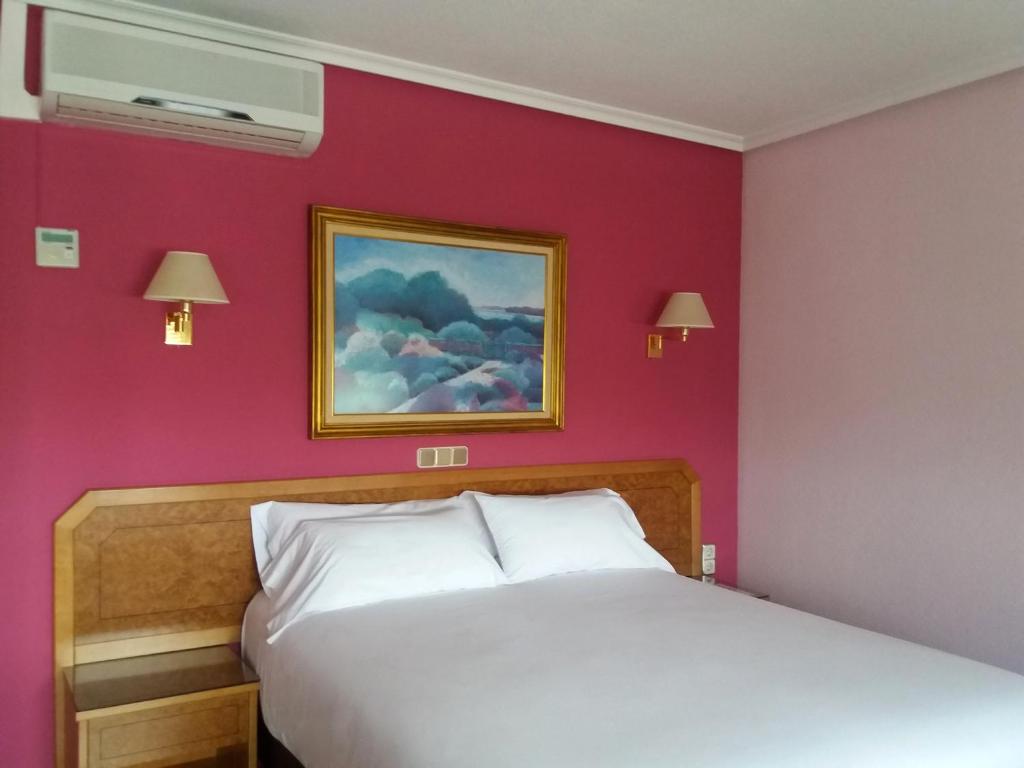 Postel nebo postele na pokoji v ubytování Hotel Don Carmelo