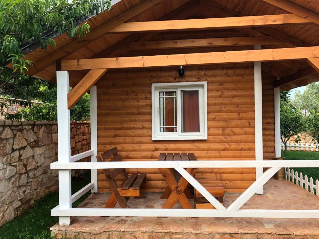 a log cabin with a porch and a window at The Mussel House in Ksamil