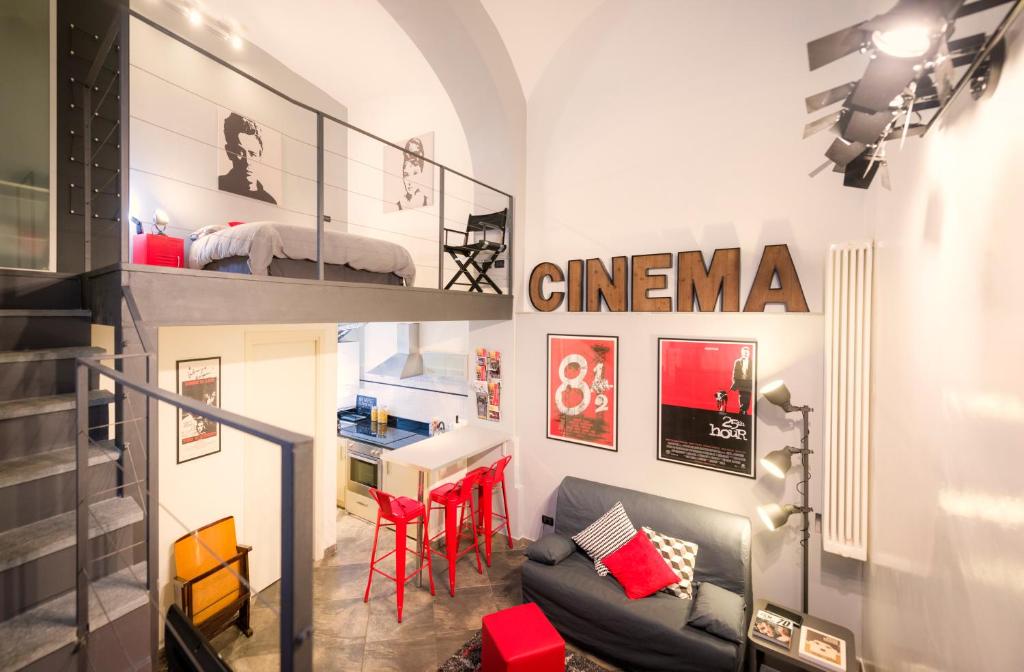 a room with a staircase with a couch and a bed at Cinema Loft in Turin