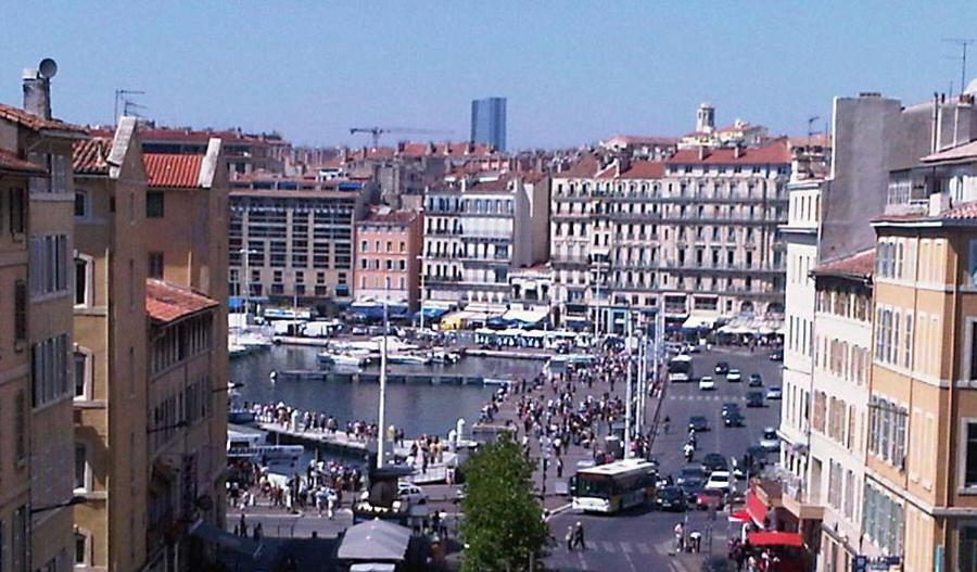 a view of a city with a river and buildings at La MAISON du PORT in Marseille