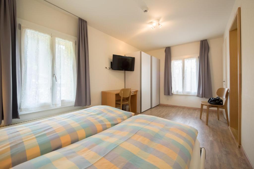 Postel nebo postele na pokoji v ubytování Hotel Alpenblick Mürren