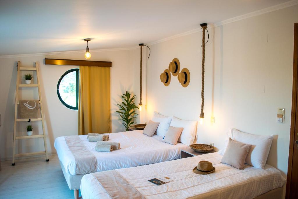 a bedroom with two beds with hats on top of them at Mesogios Beach in Kissamos