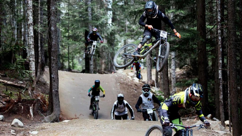 a group of people on bikes jumping in the air at Whistler Village Inn & Suites in Whistler