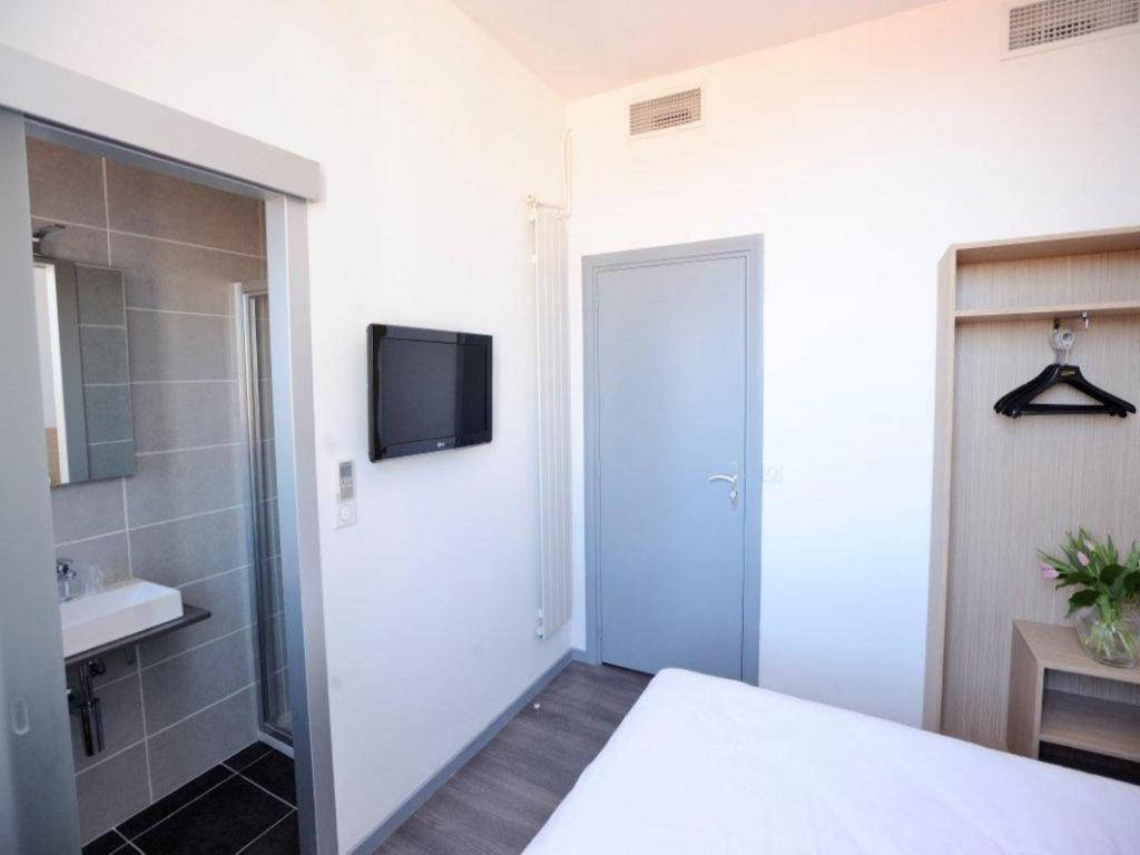 Postel nebo postele na pokoji v ubytování Hôtel de France