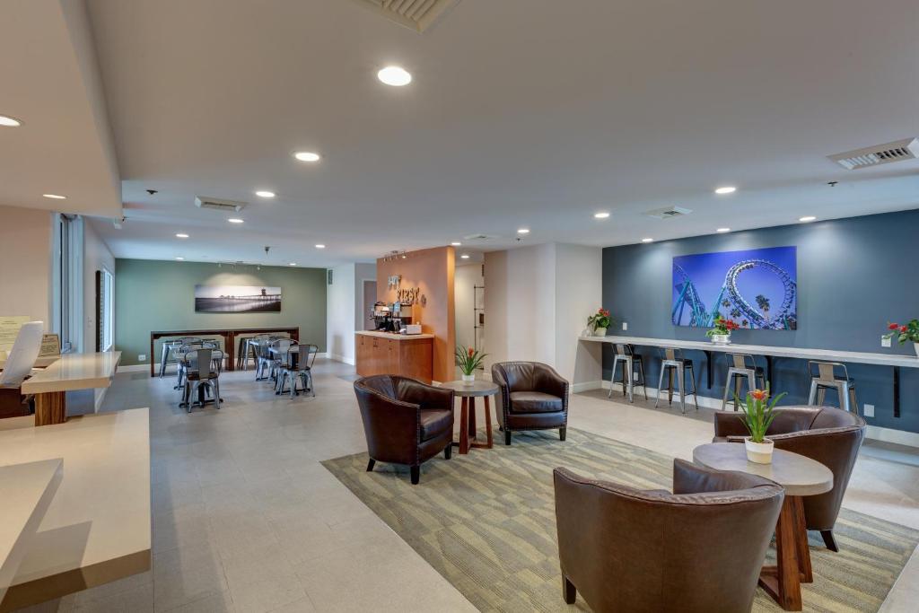 a lobby of a hospital with chairs and tables at Good Nite Inn Buena Park in Buena Park