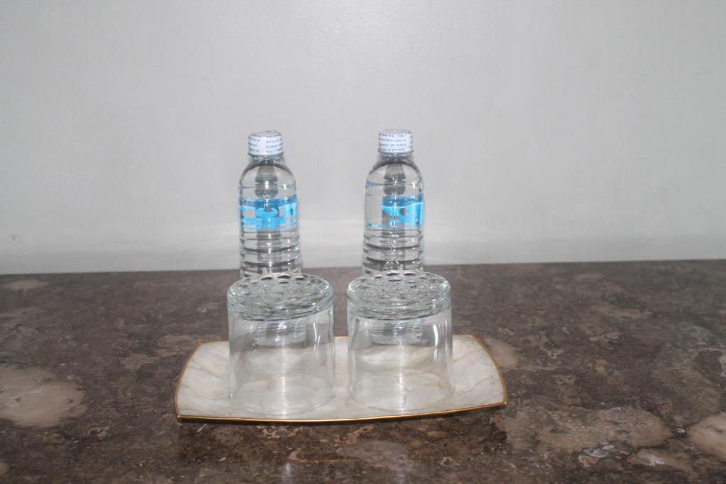 three bottles of water sitting on a cutting board at Pearl Manila Hotel in Manila