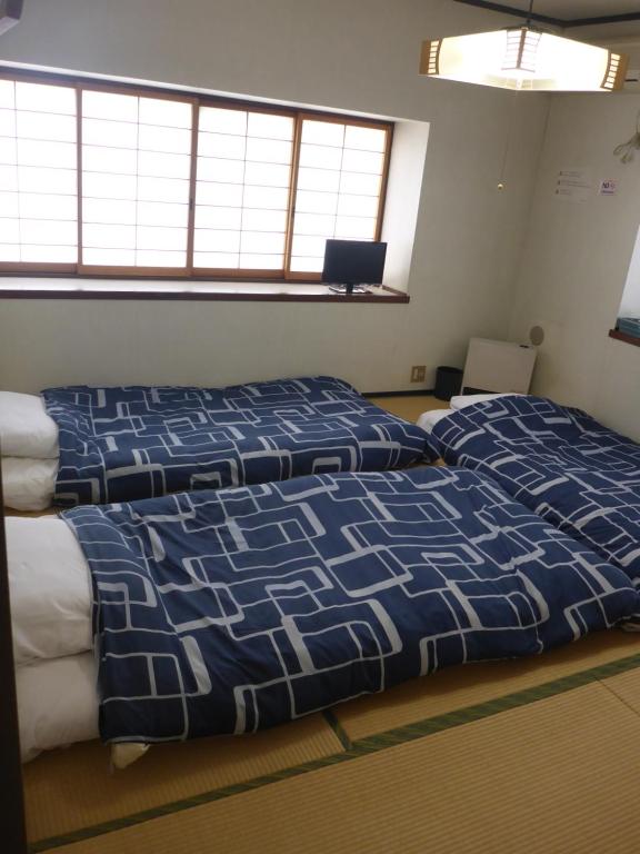 Postel nebo postele na pokoji v ubytování Nozawa Dream