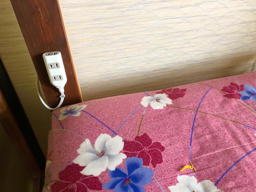 Łóżko lub łóżka w pokoju w obiekcie Guesthouse Honobono