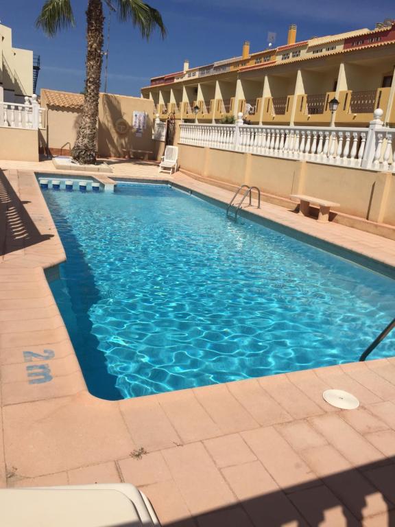 a swimming pool with blue water in a building at CL Picasso 8 in Playas de Orihuela