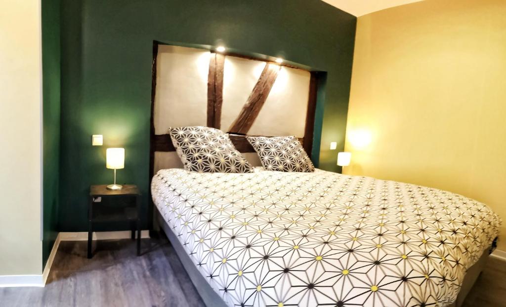 um quarto com uma cama e uma parede verde em Splendide Appartement Barr - Route du Vins em Barr