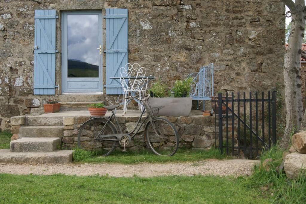 a bike parked outside of a house with a window at cool la source in Burdignes