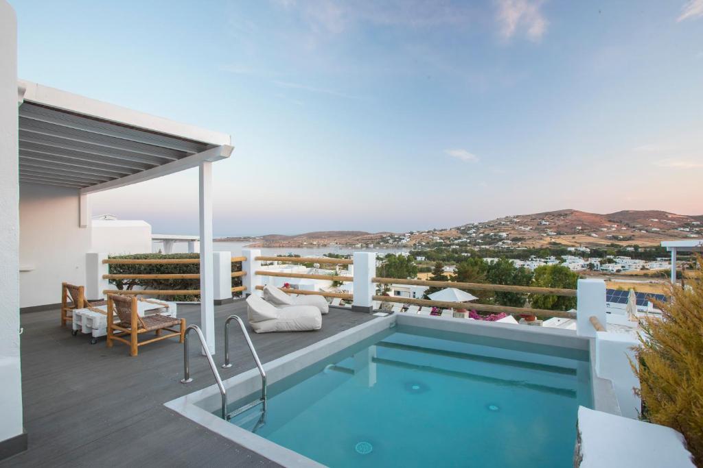 a large swimming pool with a balcony overlooking the ocean at Paros Palace in Parikia