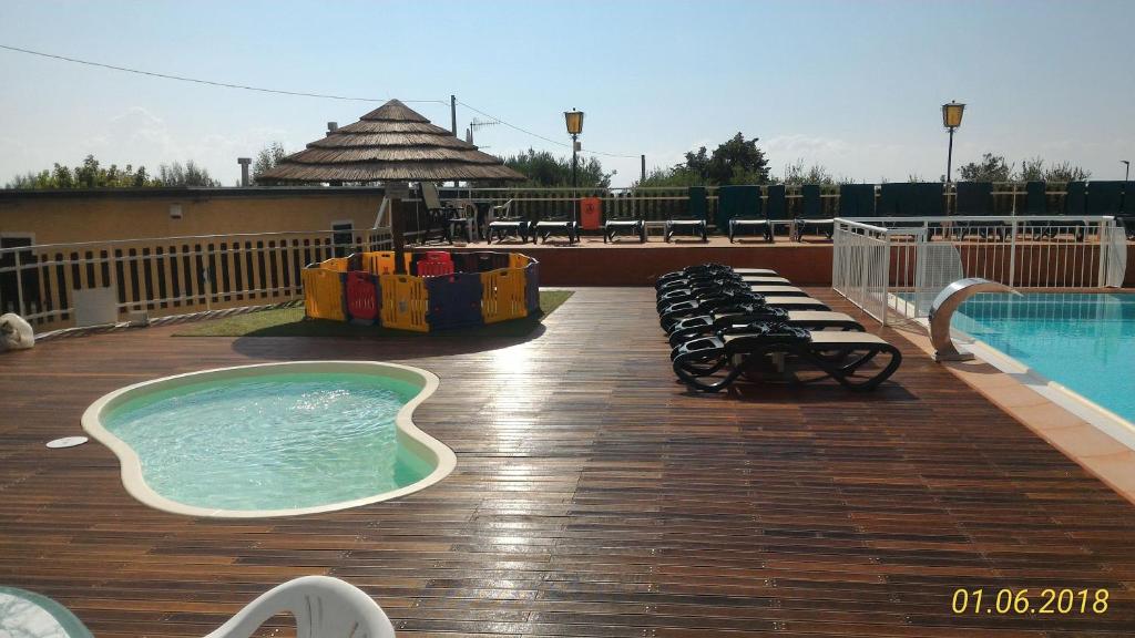 un'ampia terrazza con piscina e vasca idromassaggio di Camping Ali Baba a Ceriale