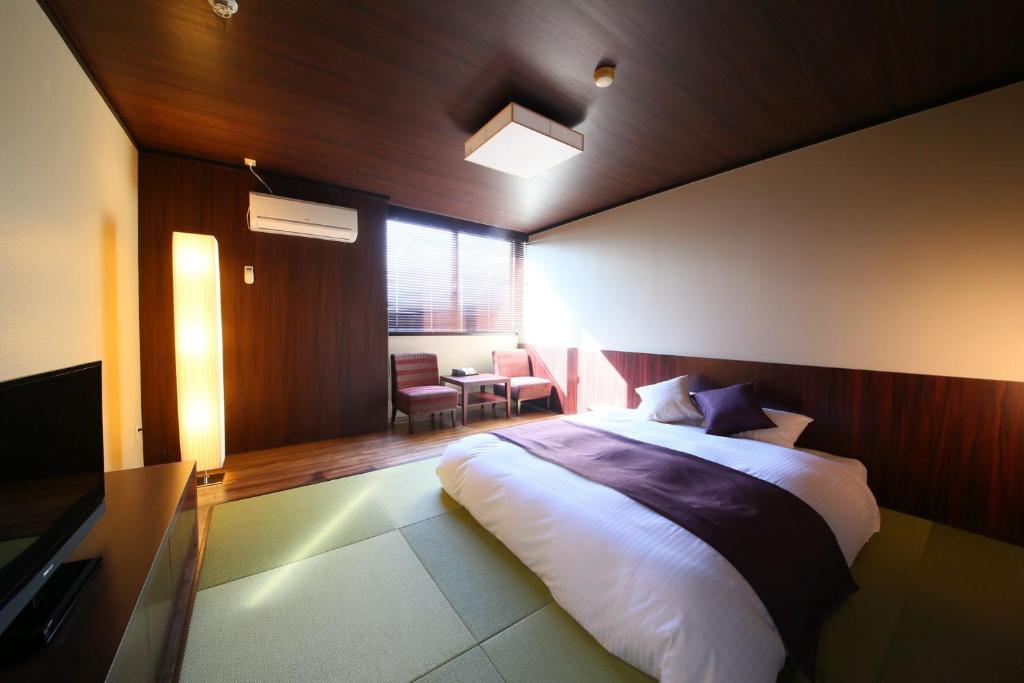 Postel nebo postele na pokoji v ubytování Nasu Ichiya Hotel