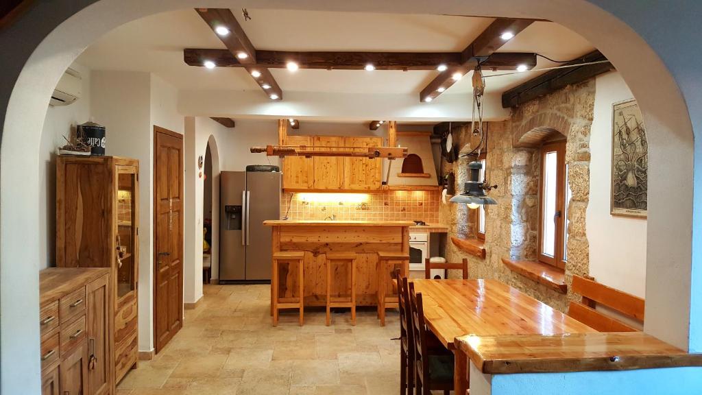 a kitchen with a large wooden table in a room at Apartment Korcula in Korčula
