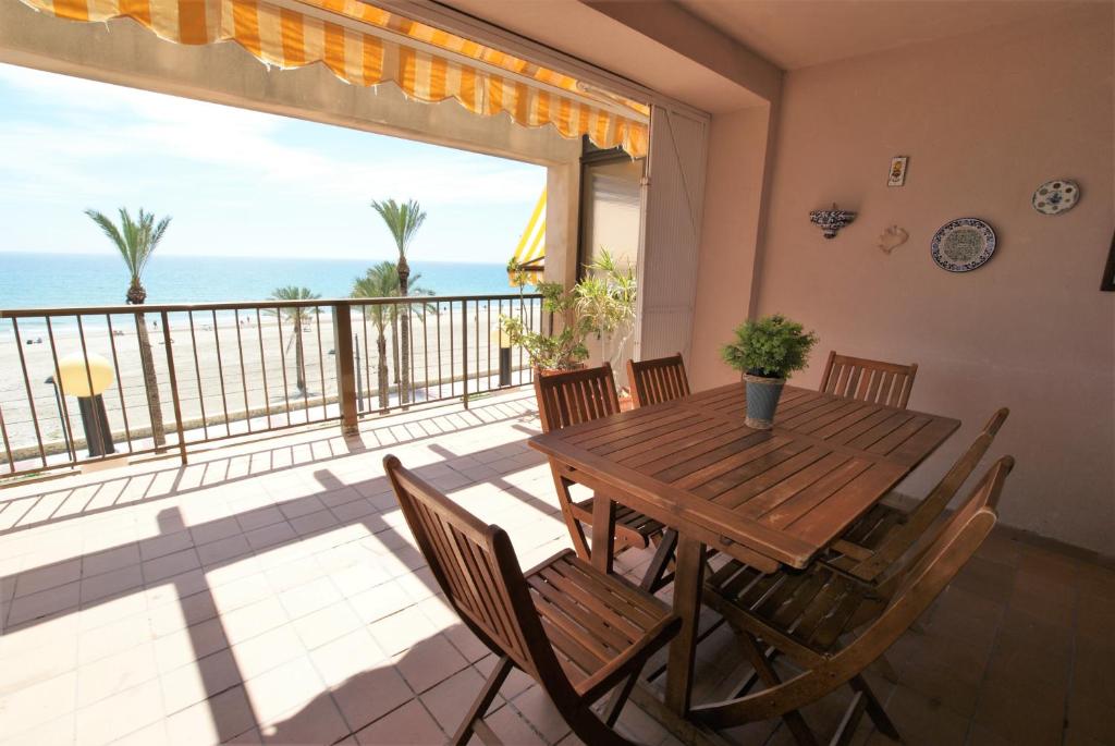 ein Esszimmer mit Tisch und Stühlen und dem Meer in der Unterkunft Stay In Mediterranean View in El Campello